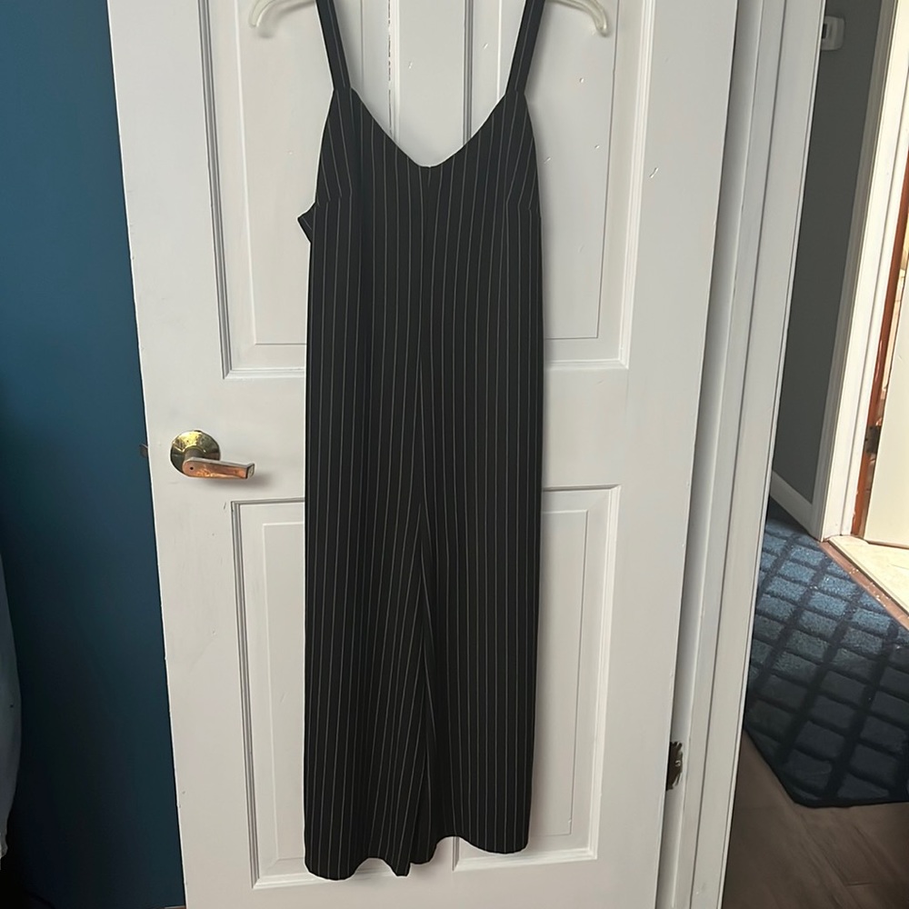 Target size M black with hint of white stripe jumper.